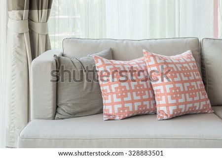 row of pillows on modern sofa in classic living room style, interior design