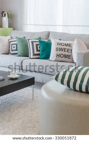 green and white pillows on round chair in modern living room