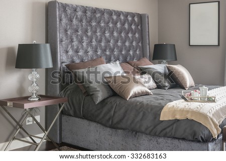 luxury bed with pillows and tray of tea set on blanket in bedroom