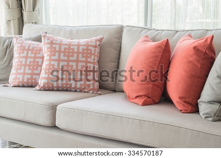 row of pillows on sofa in classic living room style, interior design