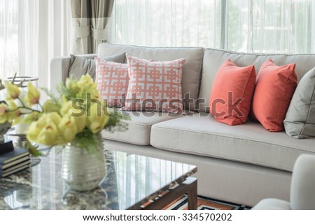 row of pillows on sofa in classic living room style, interior design, blur foreground effect