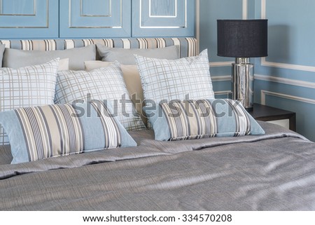 blue pillows on luxury bed in blue bedroom, interior design