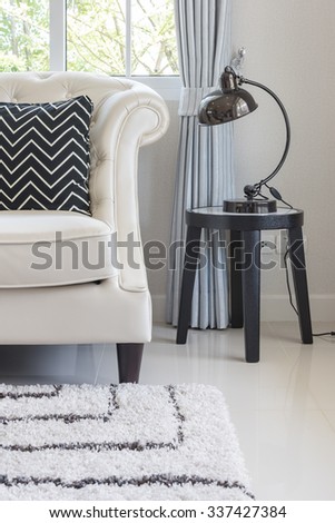 luxury living room with pillows on classic style sofa and lamp on table side
