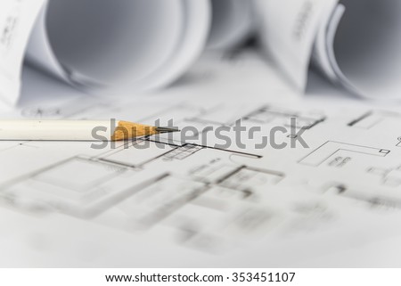 white pencil on architectural for construction drawings  with roll of blueprint
