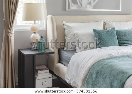 luxury bedroom with green color tone and classic lamp on table side