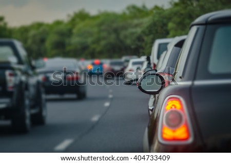 traffic jam with row of cars on express way during rush hour,  before night, selective focus as rear window
