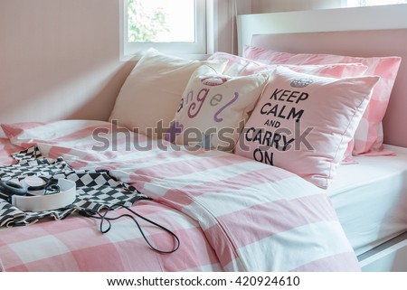 pink color tone bedroom design with pink pillows on bed