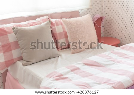 pillows on bed in pink color tone bedroom design