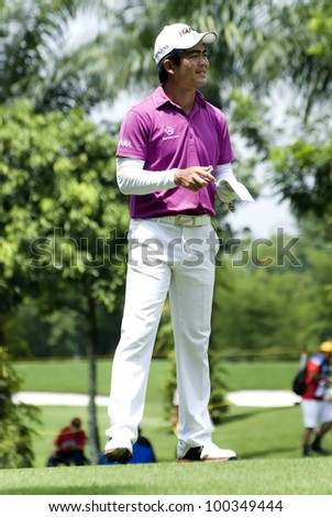 KUALA LUMPUR - APRIL 15: Liang Wen Chong of China record his shot in the scorecard after finishing hits shot in the 10th hole during final round of Maybank Malaysian Open on April 15, 2012
