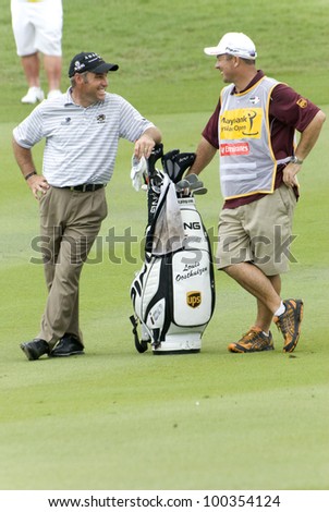 KUALA LUMPUR - APRIL 15: Hennie Otto of South Africa chatting with the caddy during final match of Maybank Malaysian Open 2012 at Kuala Lumpur Golf & Country Club on April 15, 2012