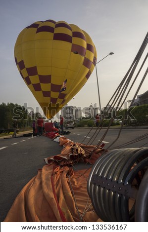 KUALA LUMPUR - MARCH 30: Balloonist of Australia, Donna Tasker has landed in the middle of the road during  5th Putrajaya International Hot Air Balloon on March 30, 2013.