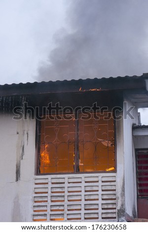 KUALA LUMPUR-FEB 12: A fire visible from the windows of a house on fire in Taman Sri Rampai, Setapak, Kuala Lumpur, Malaysia on February 12, 2014