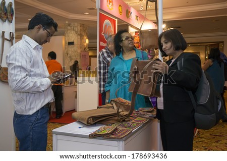 KUALA LUMPUR, MALAYSIA-JUNE 6,2013: Participant of Global Summit of Women 2013 shopping in exhibition during Global Summit of Women 2013 in Kuala Lumpur, Malaysia on June 6, 2013.
