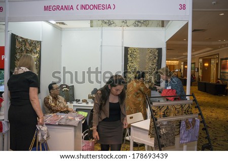 KUALA LUMPUR, MALAYSIA-JUNE 6,2013:Participant stop by at Indonesia booth to take a look closer on batik in exhibition during Global Summit of Women 2013 in Kuala Lumpur, Malaysia on June 6, 2013.