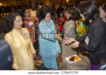 KUALA LUMPUR, MALAYSIA-JUNE 6,2013: Malaysian First Lady, Rosmah Mansor(C), arrives at the ladies forum with Irene Natividad(L)  on the first day of the summit at Kuala Lumpur, June 6, 2013.