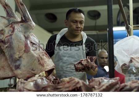 KUALA LUMPUR, MALAYSIA-FEB 26: Unidentified mutton seller at Chow Kit wet market cut the rib mutton in Kuala Lumpur, Malaysia on February 26, 2014