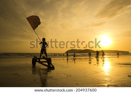 A lifeguard waving a red flag at Cenang beach, Langkawi