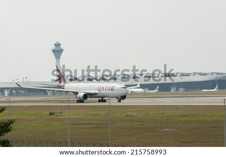 SEPANG, MALAYSIA - AUGT 4: Airbus A330 registered with number A7-AFP owned by Qatar Airways ready to take off from Kuala Lumpur International Air Port, Sepang, Malaysia on August 4, 2014.
