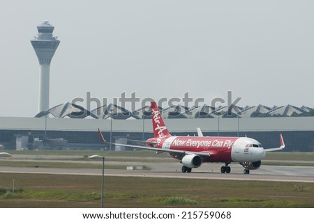 SEPANG, MALAYSIA - AUGT 4: Airbus A320 registered with number 9M-AQX owned by Air Asia ready to take off from Kuala Lumpur International Air Port, Sepang, Malaysia on August 4, 2014.