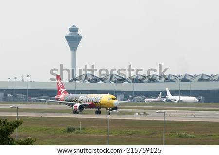 SEPANG, MALAYSIA - AUGT 4: Airbus A320 registered with number 9M-AHL owned by Air Asia ready to take off from Kuala Lumpur International Air Port, Sepang, Malaysia on August 4, 2014.