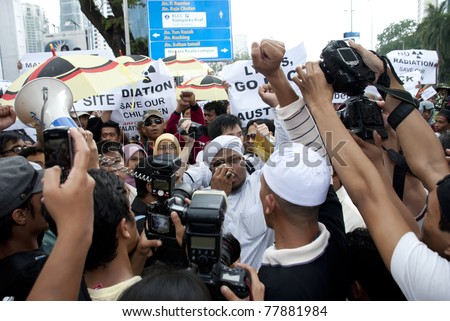KUALA LUMPUR, MALAYSIA-MAY 20: Demonstrators during a protest against a proposed rare earth plant to be built in Gebeng, in front of Petronas Twin Towers in Kuala Lumpur May 20, 2011.