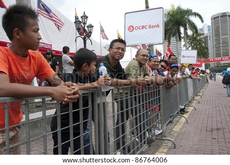 KUALA LUMPUR, MALAYSIA - OCTOBER 16: Cycling spectators lining in the race route during OCBC Cycle Malaysia in Kuala Lumpur, Malaysia on October 16, 2011.