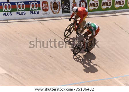 KUALA LUMPUR - FEBRUARY 9: Rider from China (red) competed with rider from Hongkong (green white) during Asian Cycling Championships 2012 held in Kuala Lumpur, Malaysia on February 9, 2012.
