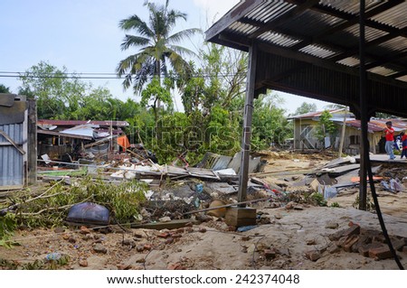 TUMPAT, KELANTAN - JANUARY 1: Wooden house almost collapse hit by flood in Tanjung Kuala village, Tumpat aftermath the worst flood that ever hit Kelantan, Malaysia on January 1, 2015