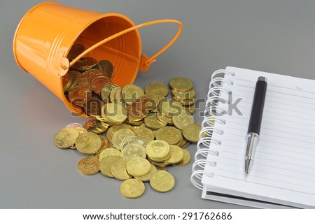 Gold Coins spilling out of bucket - Business Concept