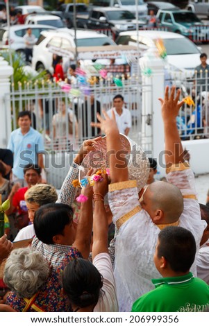 CHONBURI , THAILAND - JUNE 29: Celebration of a new buddhist monk, The new monk is thrown the money toward the many people for charity. June 29, 2014 in Chonburi , Thailand.