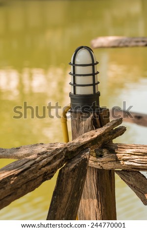 Lamp on the old wooden fence