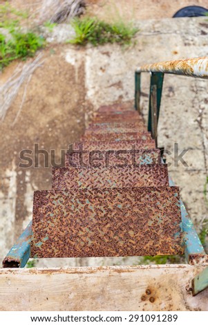 close up rusty iron stairs step down