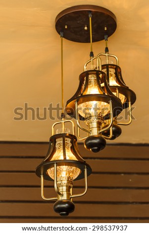 Yellow lamps with glass structure on ceiling in ballroom