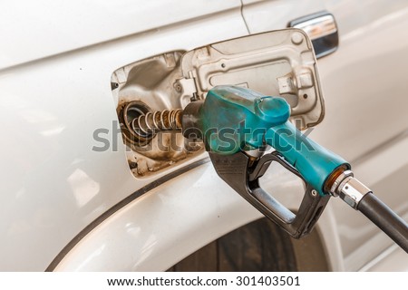 Closeup of pumping gasoline fuel into car tank