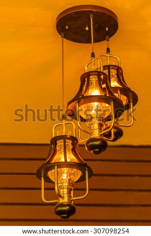Yellow lamps with glass structure on ceiling in ballroom