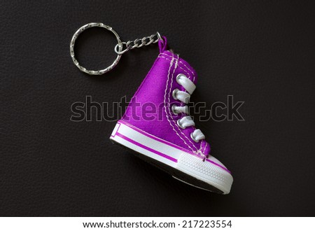 Key chain with mini basketball shoe on leather pad