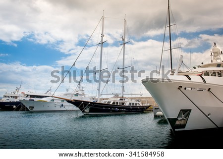 Yacht Club with luxury yachts and motor boats under a dramatic cloudscape at the marina Zeas near Piraeus Port. Greece