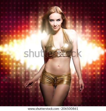 attractive woman in clubwear in front of a flood  light
