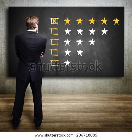 businessman watching a five star rating