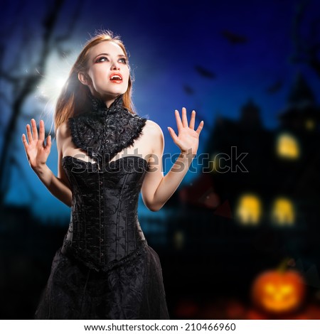 sexy vampire in front of a halloween house