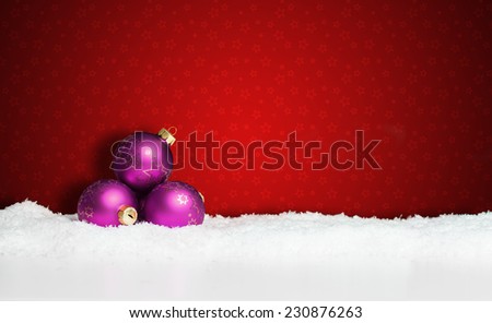 many christmas balls in the snow
