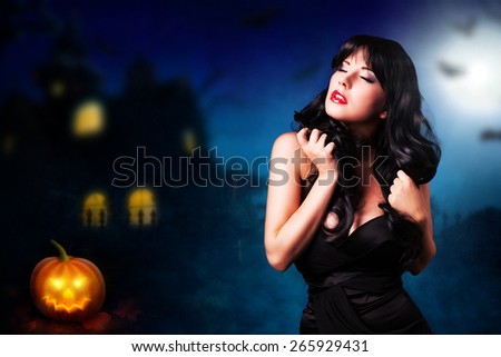young attractive woman in front of a halloween house