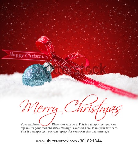 christmas ball in the snow with merry christmas greeting and sample text