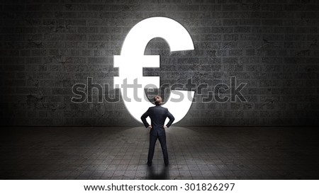 businessman standing in front of a portal shaped as a euro-symbol