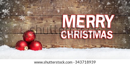 christmas ball in the snow with merry christmas greeting
