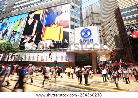 HONG KONG - MARCH 27: People walking across Hennessy Road, Causeway Bay in front of a big department store Sogo at Day. Hong Kong march 27, 2014.