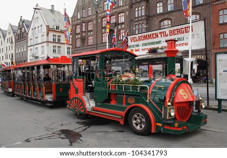 BERGEN, NORWAY - JULY 10: A tschu tschu road train in Bergen, Norway, on 10 July 2011. The driver and some passengers wait to depart on a tour of the city from the UNESCO World Heritage Site, Bryggen.