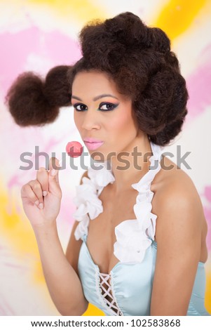 Beautiful afro-american woman holding lollipop