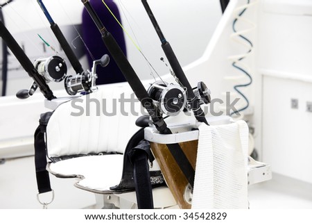 Four Fishing Pole Rods and Reels and a fishing chair