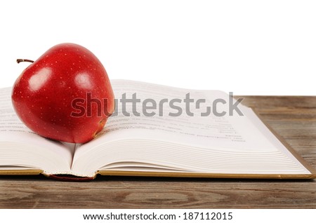 Open book with apple isolated on white